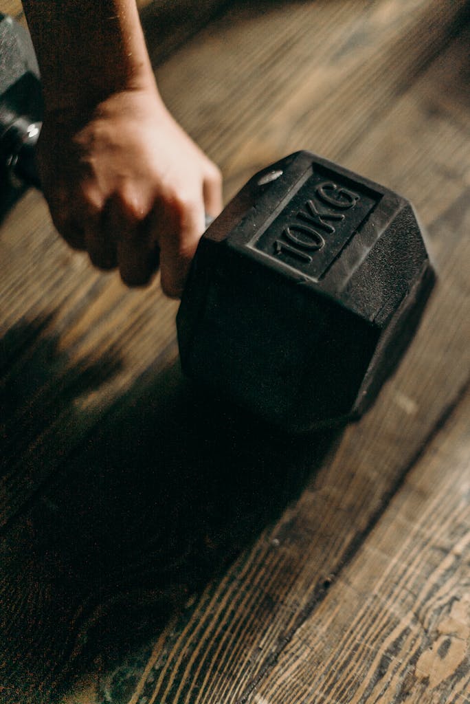 Black Dumbbell on Brown Wooden Table